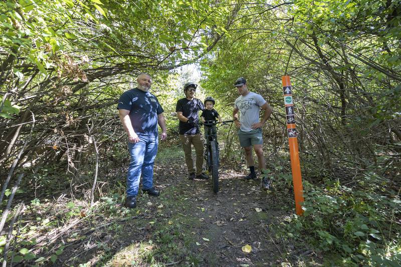 Rock River Valley Bike Club members Brian Seagren (left), Scott Fenwick and son Leo and Ryan Elmendorf talk about the work the group puts in to maintain the trails in Dixon on Saturday, Sept. 28, 2024.