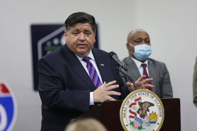 Governor J.B. Pritzker speaks about the Rebuild Illinois project, as IDOT Secretary of Transportation Omer Osman looks on, at a press conference held at Joliet Junior College. Thursday, Jan. 20, 2022 in Joliet.
