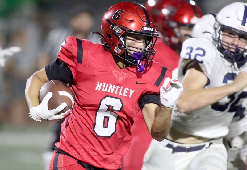 Huntley’s Michael Chan turns the corner on a run against Cary-Grove in varsity football at Huntley High School in Huntley on Friday, Sept. 19, 2025.