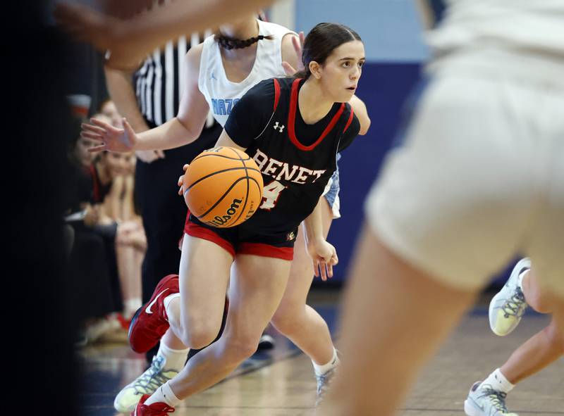 Benet's Ava Mersinger (4) drives to the basket during a girls varsity basketball game between Benet and Nazareth academies on Saturday, Dec. 14, 2024 in La Grange Park.