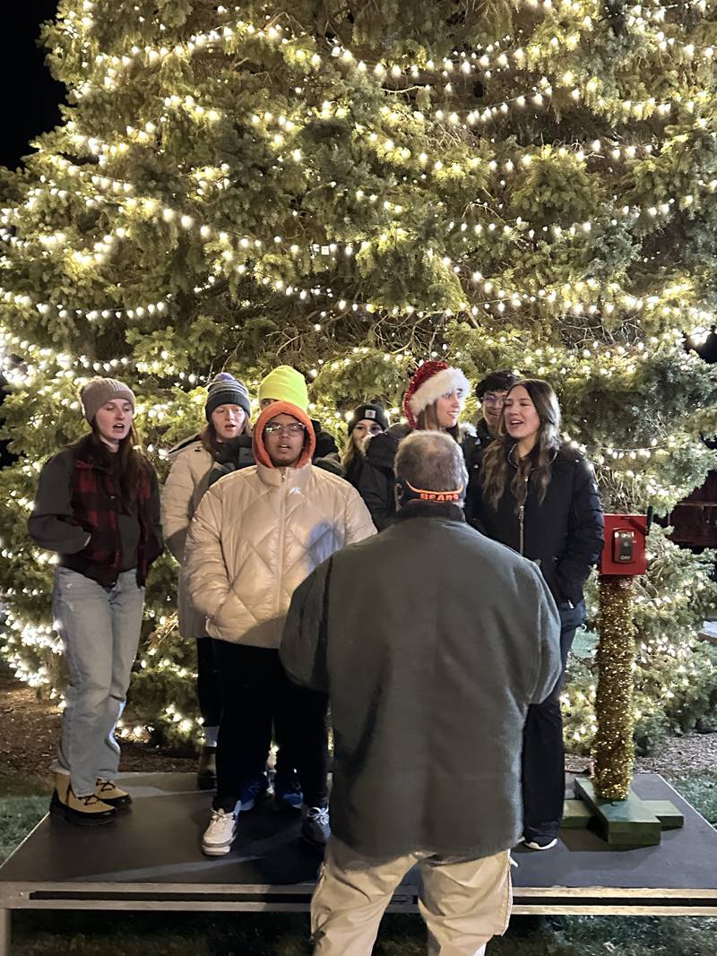 Carolers sing in front of the lighted tree during the annual Celebrate the Season event hosted by the Genoa Area Chamber of Commerce on Dec. 6, 2024, downtown.