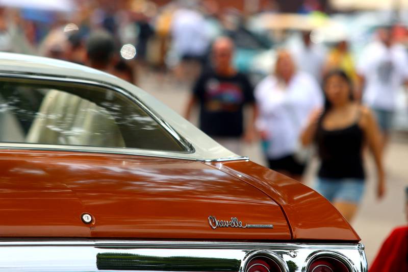 People look at classic cars during Fiesta Days at Petersen Park in McHenry Sunday.