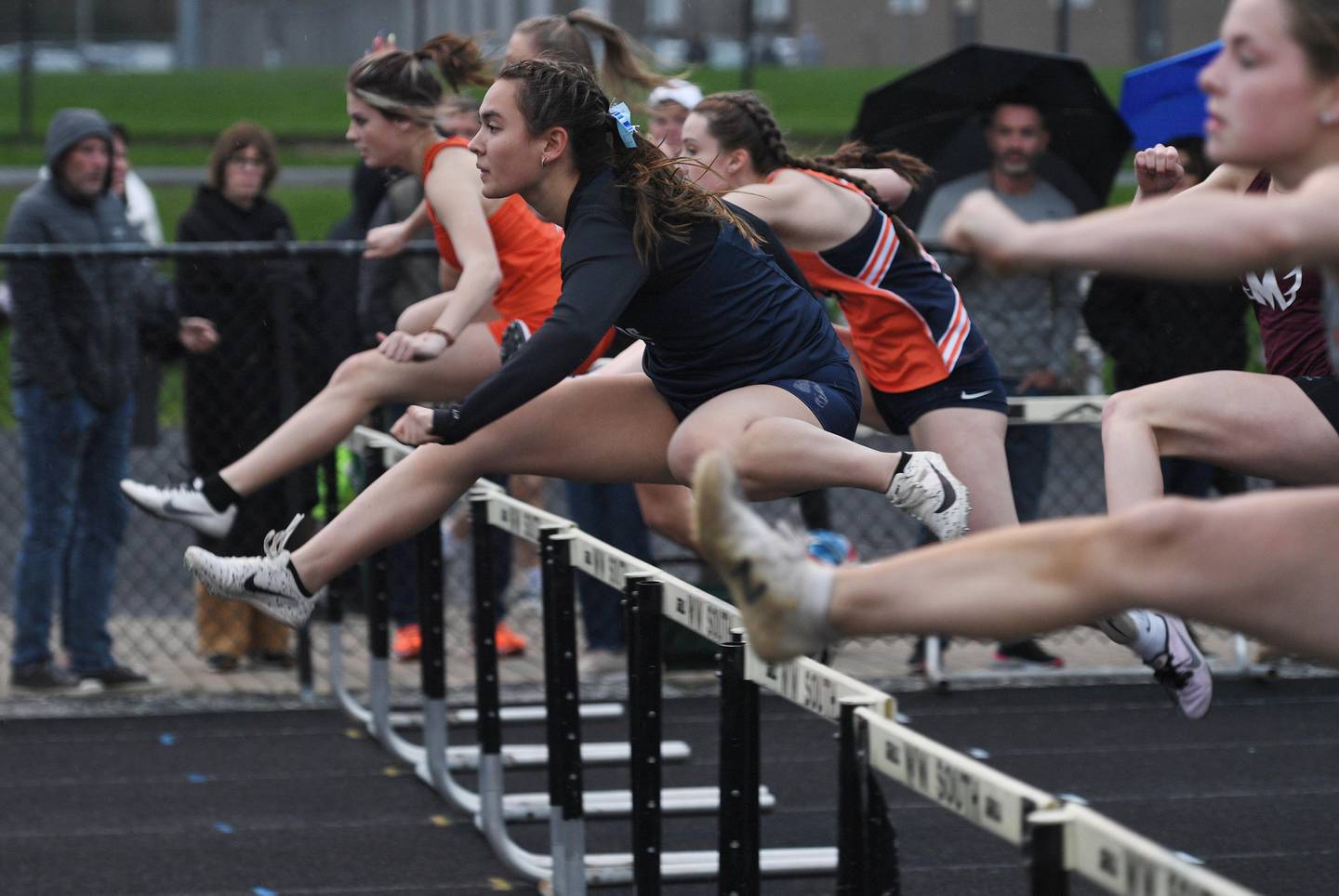Downers Grove South’s Elise D’Aquila leads heat four of the 100-meter hurdles at the Wheaton Warrenville South girls track invitational in Wheaton on Friday, April 29, 2022.