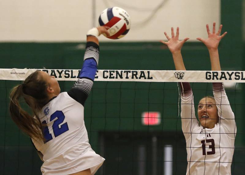 St. Francis' Jenna Glaudel threes to hit through the block of Prairie Ridge's Abigail Smith during the IHSA Class 3A Grayslake Central Supersectional volleyball match on Monday, Nov. 11, 2024, at Grayslake Central High School.