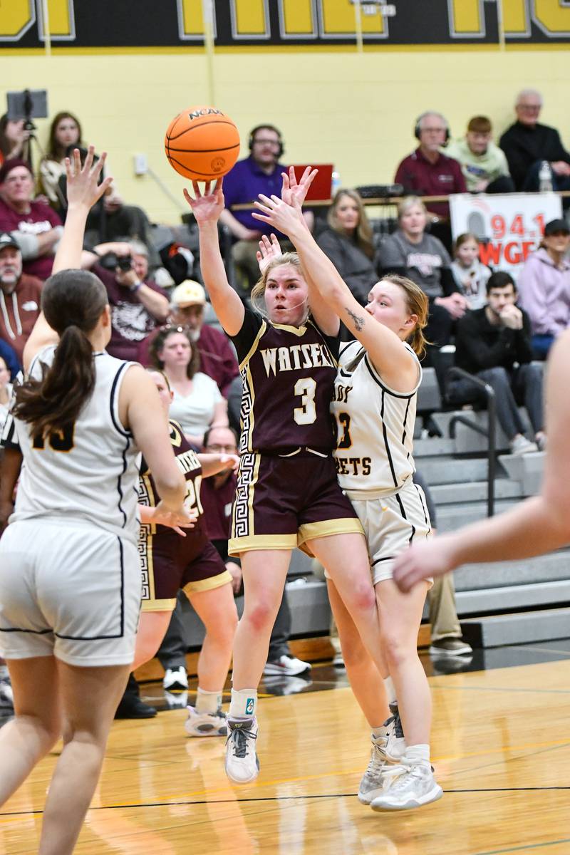 Watseka's Rennah Barrett shoots under pressure from Reed-Custer's Cameron Wallace during the Warriors' 50-24 victory over Reed-Custer in the IHSA Class 2A Herscher Sectional semifinal on Tuesday, Feb. 25.