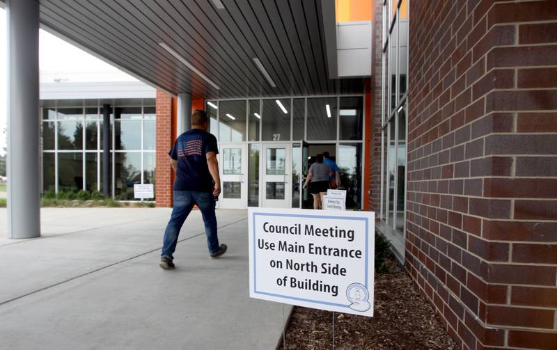 People file in as the McHenry City Council on Monday, Aug. 7, 2023, addressed a Jack Pease proposal to mine 110 acres at Route 120 and Chapel Hill Road. The meeting was held in McHenry High School’s Upper Campus auditorium.