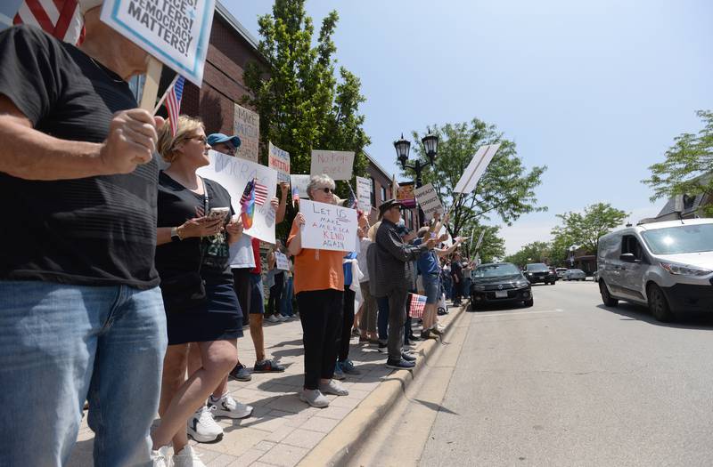 Up to an estimated 1,200 people gather outside Elmhurst City Hall while participating in the nationwide No Kings Day Rally Saturday June 14, 2025. Supports honked their horns while driving past them.