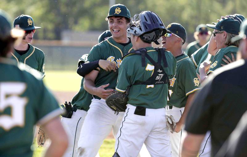 Crystal Lake South's Ysen Useni, center, is mobbed by teammates after defeating Grayslake Central during the IHSA Class 3A sectional semifinals, Thursday, June 2, 2022 in Grayslake.