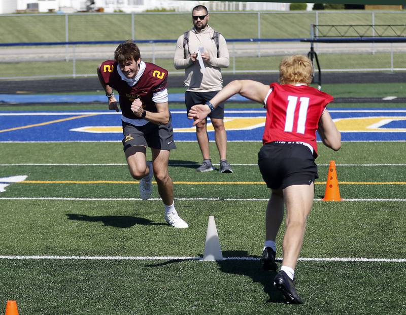 Richmond-Burton's Jace Nelson and Marian Central's Maxwell Kinney runs a timed drill at the Northern Burbs Football Showcase on Monday, May 4, 2026, at Johnsburg High School. Over 165 players from 15 teams demonstrated their football skills to over 60 college coaches.
