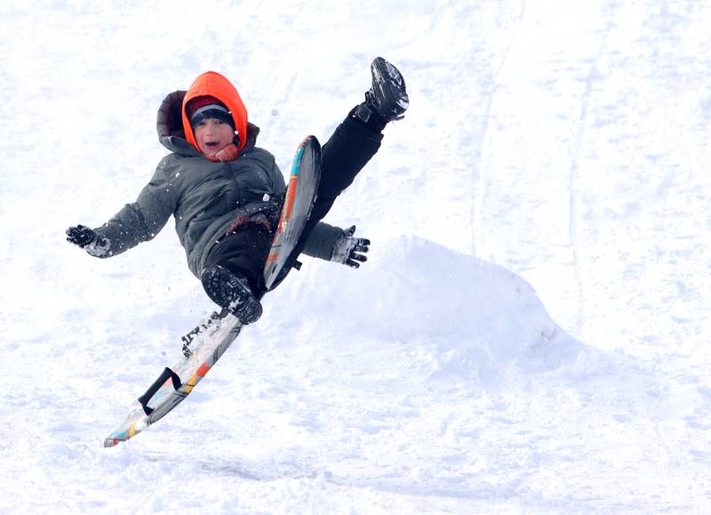 JJ Niemic, 5, of Woodstock gets air at the Emricson Park sledding hill in Woodstock Saturday in the wake of overnight snow.