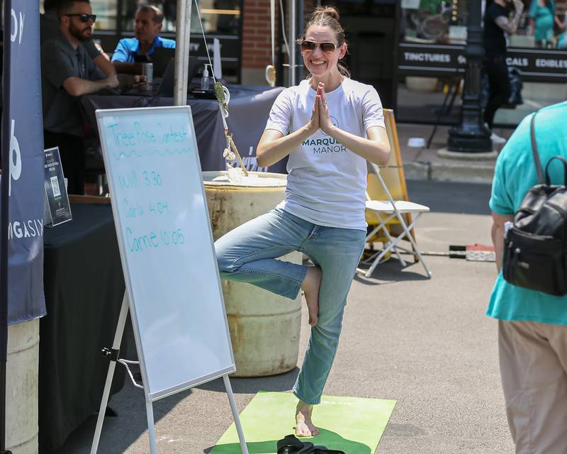 Kristin Skelton competes in the Yoga Tree pose contest hosted by YogaSix at the Downers Grove Rotary GroveFest in downtown Downers Grove. June 24, 2023.
