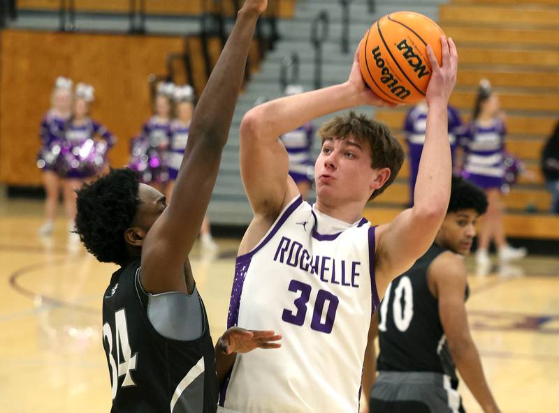 Rochelle's Warren Schwietzer tries to shoot over Kaneland's Jeffrey Hassan Tuesday, Feb. 3, 2026, during their game at Rochelle High School.