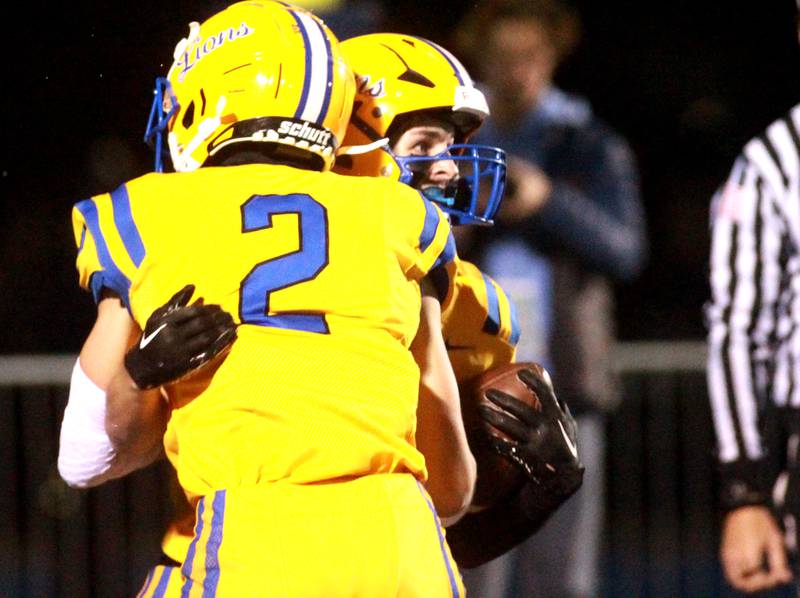 Lyons Township’s Travis Stamm (left) and Jack Cheney celebrate Cheney’s touchdown during the Class 8A second round football playoff game against York in Western Springs on Saturday, Nov. 4, 2023.