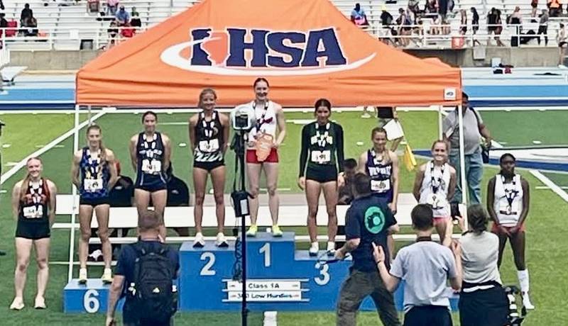 St. Bede senior Lily Bosnich takes her spot on the awards stand for third place in the 300-meter hurdles in Saturday's 1A finals in Charleston.