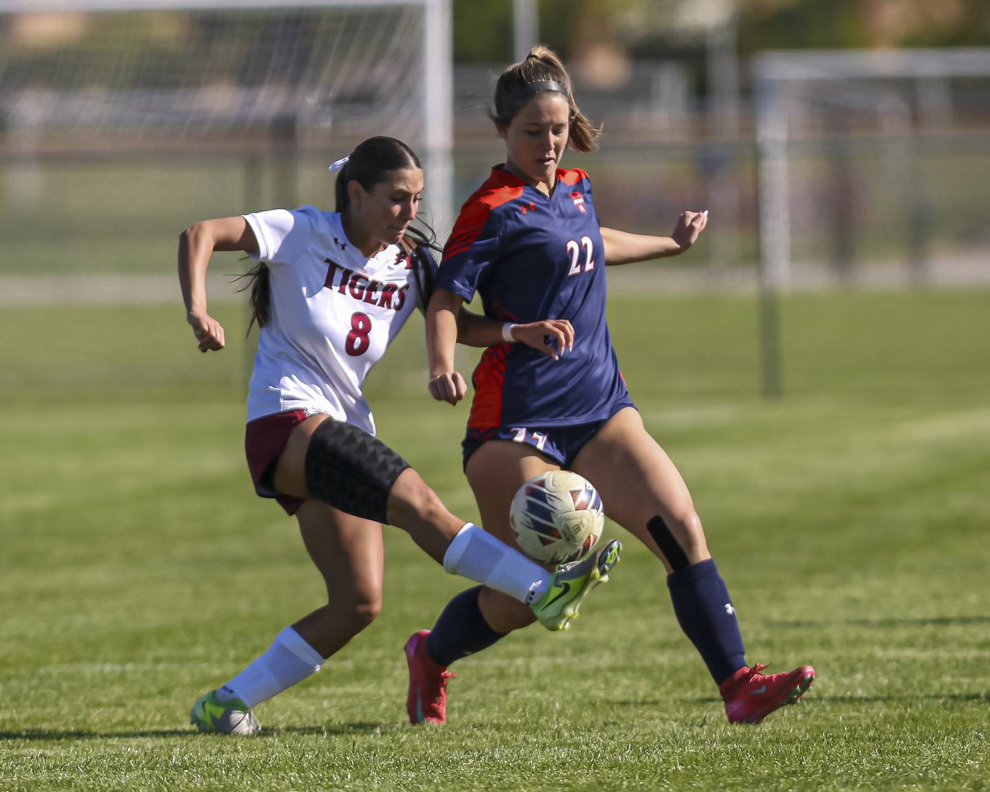 Plainfield North's Delaney Harwood (8) is defended by Oswego's Aubrey Atkins (22) during a soccer match between Plainfield North at Oswego on Monday, May 11, 2026 in Oswego.
