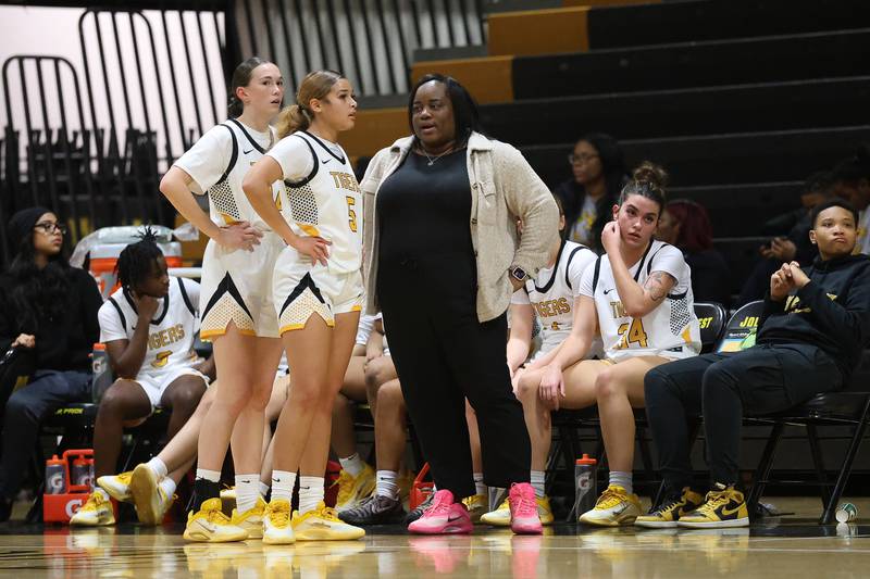Joliet West head coach Breanna Blackmon talks to a few of her players against Butler College Prep on Tuesday, Dec. 16, 2025 in Joliet.