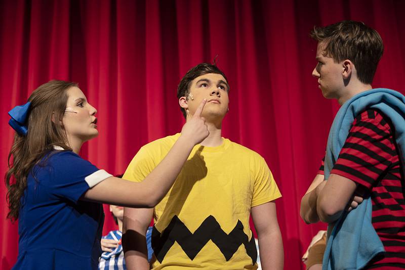 Lucy, Charlie Brown and Linus, played by Gianna Sagel, Logan Devine and Ryan Welty, rehearse the opening scene for Newman High School’s “You’re a Good Man Charlie Brown,” on Tuesday, March 7, 2023. Performances will be March 9, 10 and 11 at 7 pm and March 12 at 2 pm at the Jerry Mathis Theatre at Sauk Valley College.