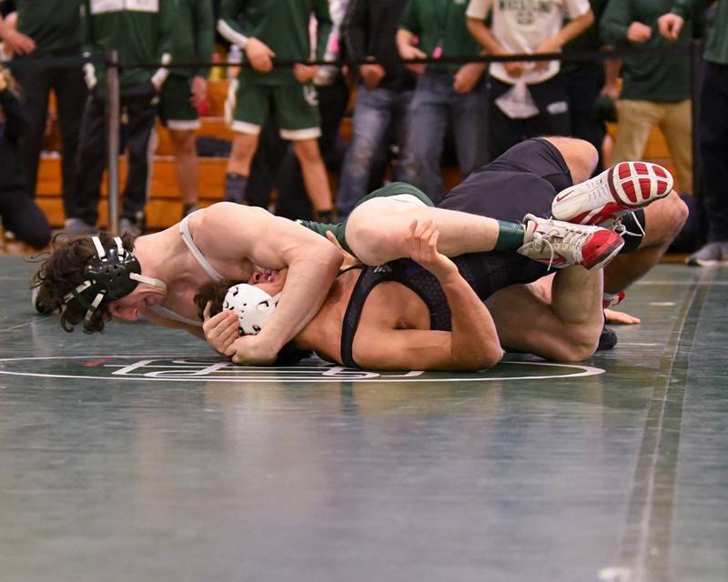 Tony Shadid, top, of Glenbard West pins Marmion Academy wrestler Christian Favia in the  157 weight class during regional championship title match on Saturday Feb. 3, 2024, held at Glenbard West High School.