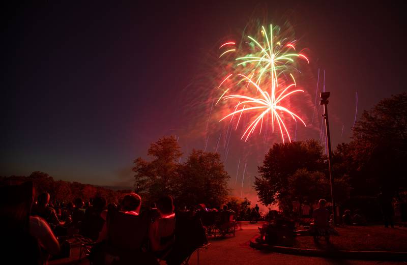 Attendees gather to watch fireworks during North Aurora's annual Independence Day celebration  at Riverfront Park in North Aurora on Monday, July 3, 2023.