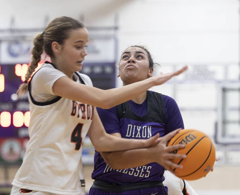 Dixon's Hallie Williamson is fouled by Byron’s Macy Groharin Friday, Dec. 27, 2024, during the Dixon Girls KSB Holiday Basketball Classic.