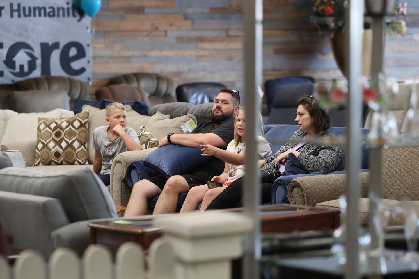 A family tests out a couch at Habitat for Humanity ReStore on Thursday, July 13th, 2023 in Joliet.