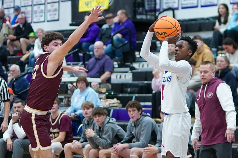 Marmion's David Malley (1) shoots a three pointer against Morris’ Colin Pfeifer (24) during a basketball game in the opening round of the 61st annual Plano Christmas Classic at Plano High School on Monday, December 23, 2024.
