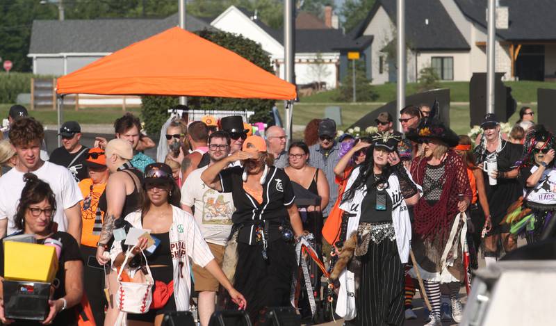 Fans dressed in Halloween theme costume enter for the Illinois Valley Pistol Shrimp Halloween in July on Wednesday, July 23, 2025 at Schweickert Stadium in Peru. The event featured a Trick or Treat Scavenger Hunt presented by Peru Federal Savings Bank, Pregame Performance from the Hocus Pocus Hags and a kids costume parade.