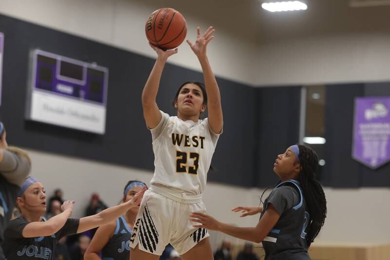 Joliet West’s Miranda Rosales puts up a shot against Joliet Catholic in the WJOL Basketball Tournament at Joliet Junior College Event Center on Monday