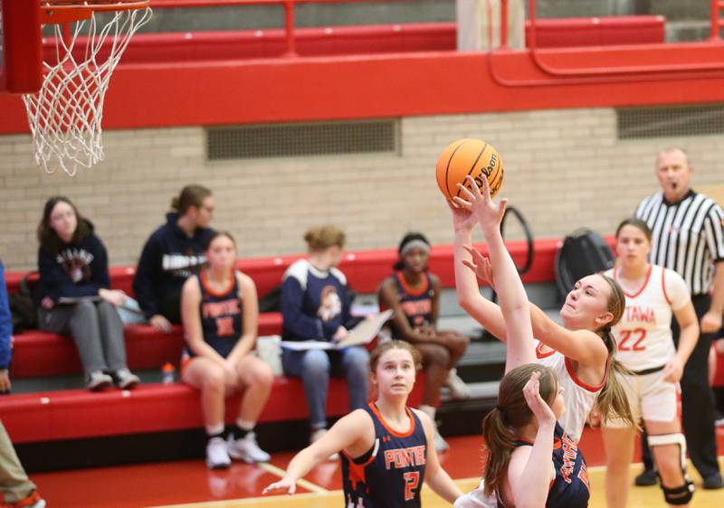 Ottawa's Ashlyn Gainiere eyes the net while running in the lane fighting off Pontiac defenders during the Ottawa Girls Holiday Tournament on Monday, Dec. 16, 2024 in Kingman Gym at Ottawa High School.