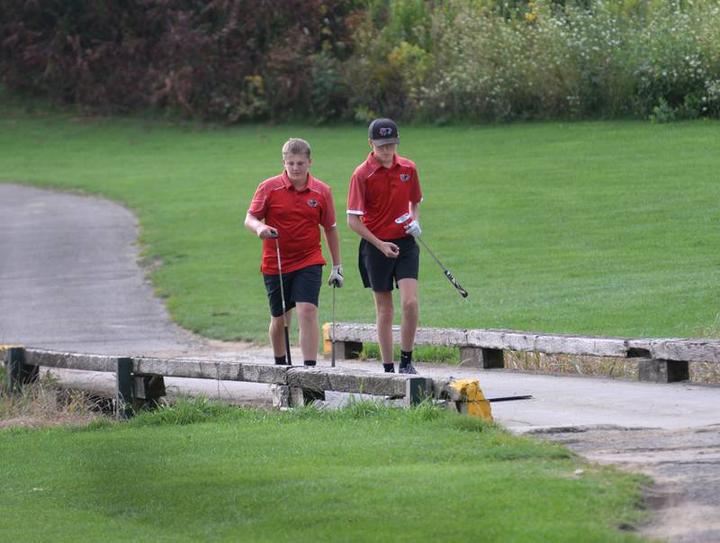 Erie-Prophetstown's Callen Keegan (right) and Kenny Gerlach walk across a bridge to the green at Silver Ridge Golf Course during a Monday, Aug. 18, 2025 match with Oregon High School.
