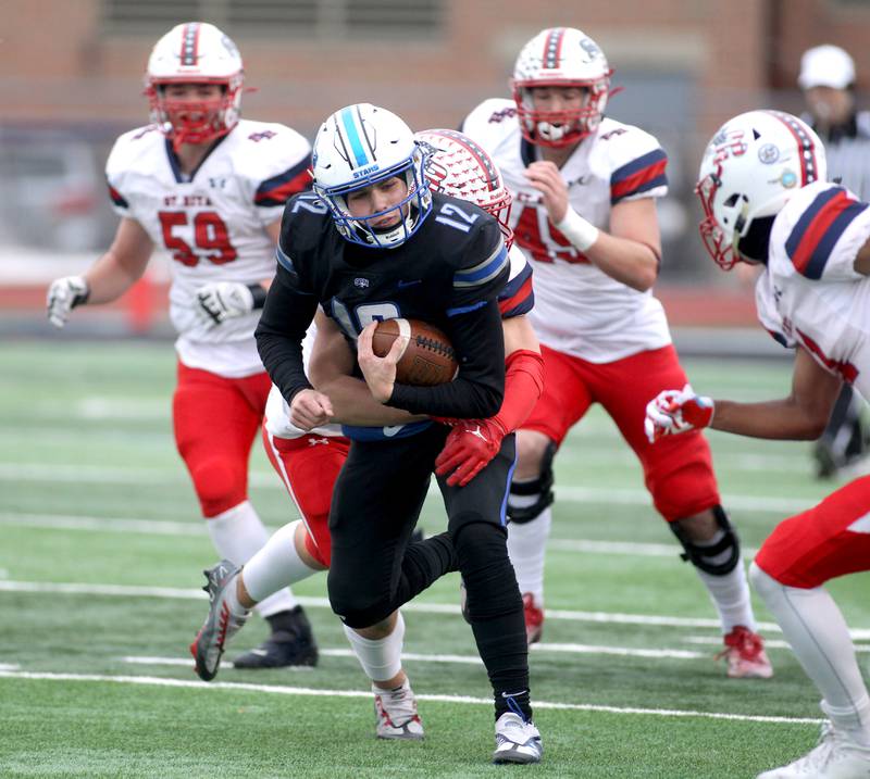 St. Charles North quarterback Will Vaske keeps the ball during their 7A quarterfinal game against St. Rita in St. Charles on Saturday, Nov. 12, 2022.