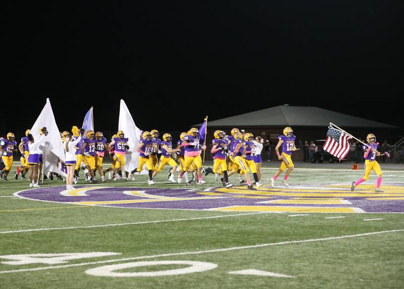Members of the Princeton High School football team run onto the field on Friday, Oct. 11, 2024 at Mendota High School.