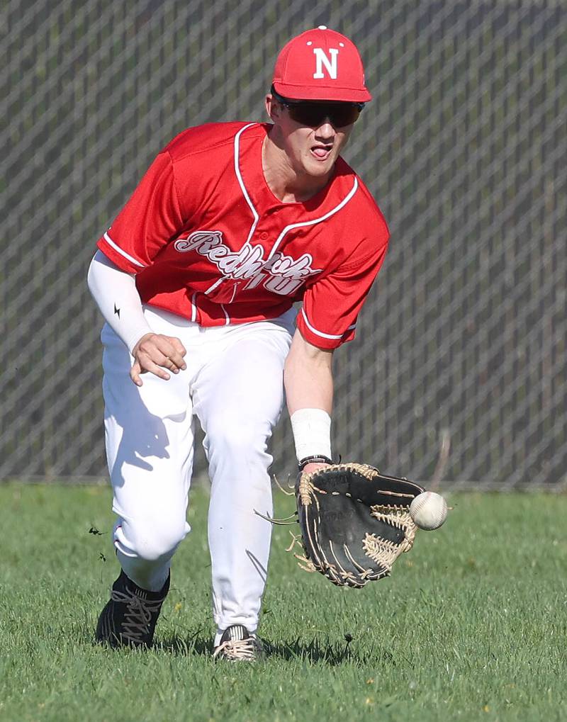 Naperville Central's Bill Enright makes a play in right field during their game against DeKalb Tuesday, April 30, 2024, at DeKalb High School.