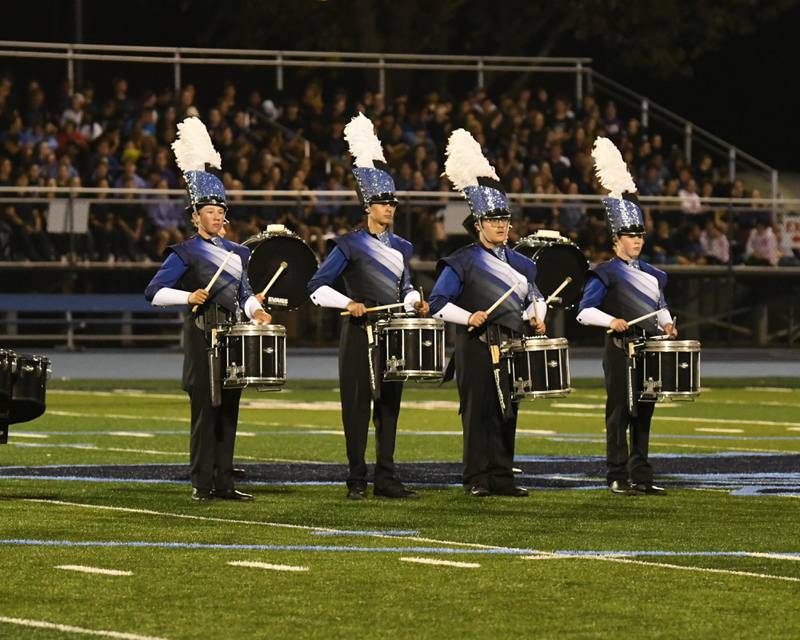 Downers Grove South drumline preforms along with the band on Saturday Oct. 5, 2024, during the Downers Grove South Marching Mustang held at the Downers Grove South High School football field.