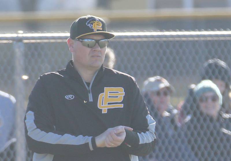 Putnam County head baseball coach Chris Newsome coaches on the third base side against Hall on Monday, March 17, 2025 at Putnam County High School.