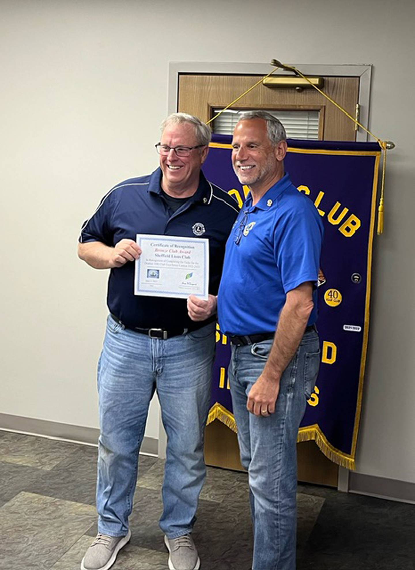 Al Corwin (left) receives an Excellence Club Award for the Sheffield Lions Club from Tom Drez, District 1-BK first vice district governor.