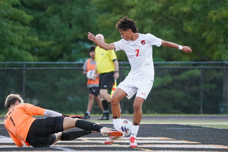 Wheaton Warrenville South's Daniel Karajic (1) makes a kick save against Oswego’s Enrique Castaneda (7) during a soccer match at Wheaton Warrenville South in Wheaton on Thursday, Aug 28, 2025.