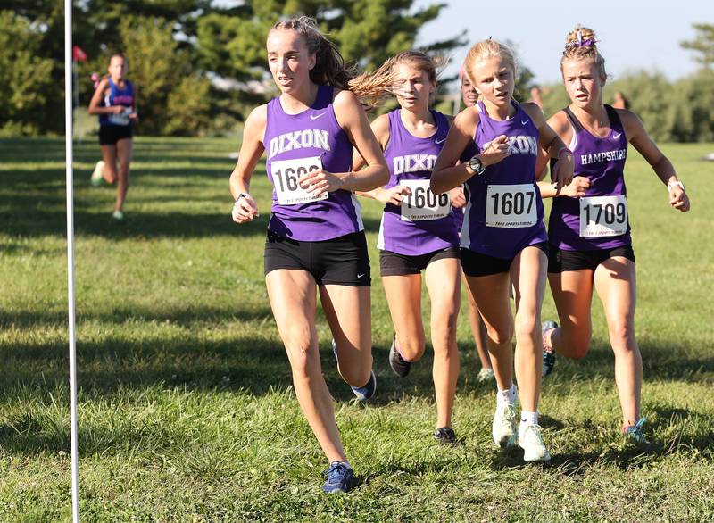 A group of Dixon runners make a turn in the girls race Tuesday, Aug. 30, 2022, during the Sycamore Cross Country Invitational at Kishwaukee College in Malta.