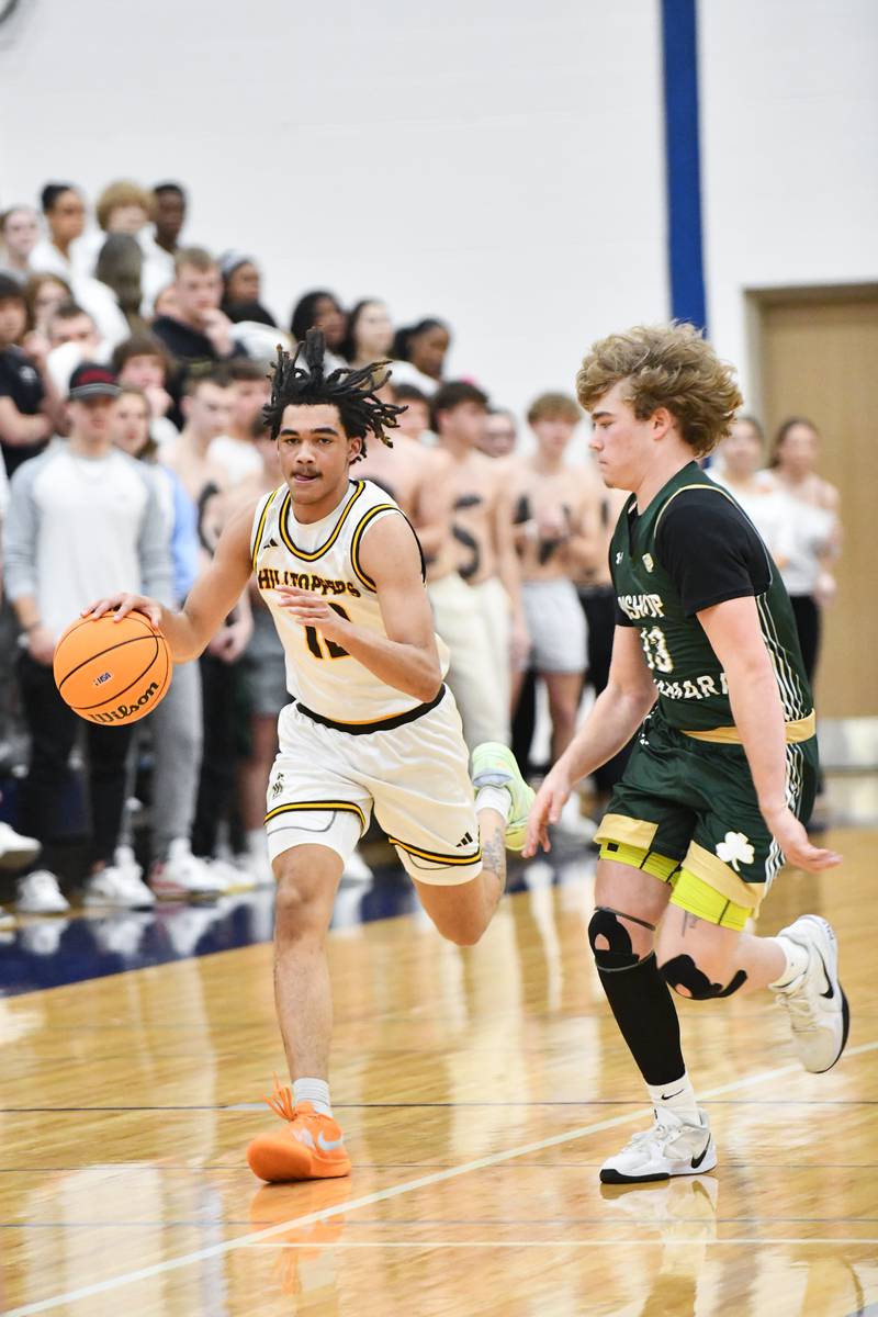 Joliet Catholic Academy's JJ Sterrett brings the ball up the court during the Hilltoppers' 79-67 loss to Bishop McNamara in the IHSA Class 2A Peotone Sectional semifinal on March 4, 2025.