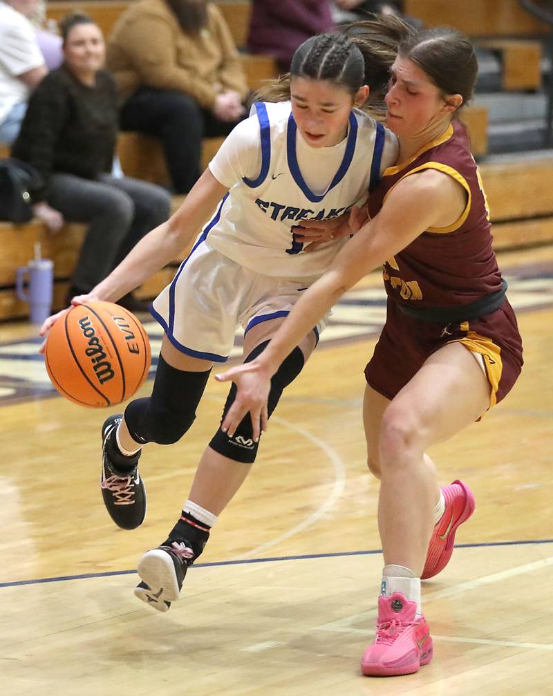 Woodstock's Alex Nowacki tries two drive to the basket against Richmond-Burton's Daniella Mazzola during a Kishwaukee River Conference girls basketball game on Wednesday, Jan. 28, 2026, at Woodstock High School.