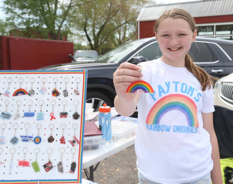 Payton Etcheid holds a rainbow key chain that she made to sell during the 2nd Annual Lemonade Day for Young Entrepreneurs on Saturday, May 4, 2024 at Country Kids in Utica.