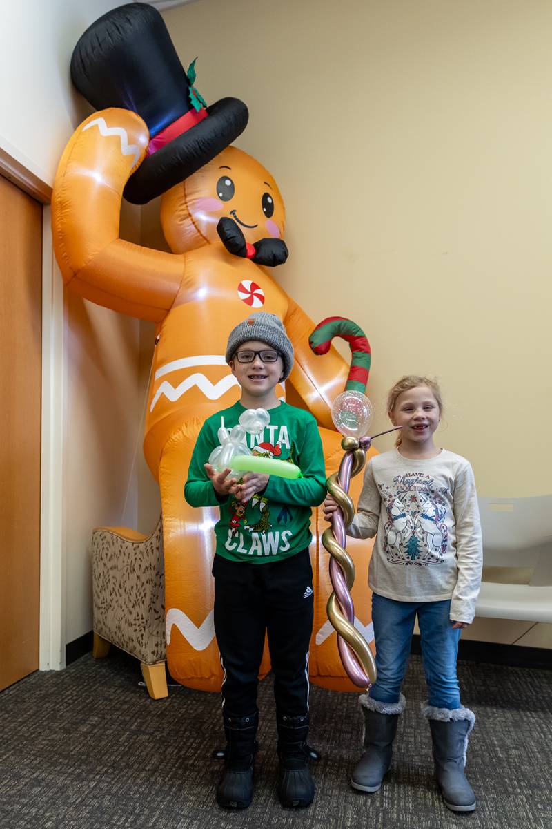 Dylan and Ella Tazelaar, of Lockport, take a photo by a giant gingerbread character at the White Oak Library District’s Lockport Branch during Lockport’s Christmas in the Square festivities on Nov. 29, 2025.