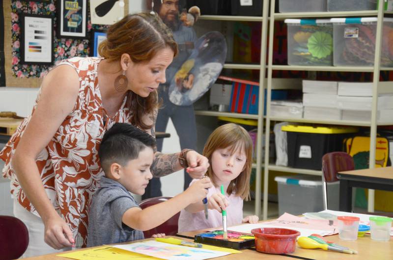 Grande Reserve Elementary art teacher Lindsey Moore instructs Yorkville students JD Colon and Anastasia Dabros during filming of a professional development video for art teachers. (Lucas Robinson - lrobinson@shawmedia.com)