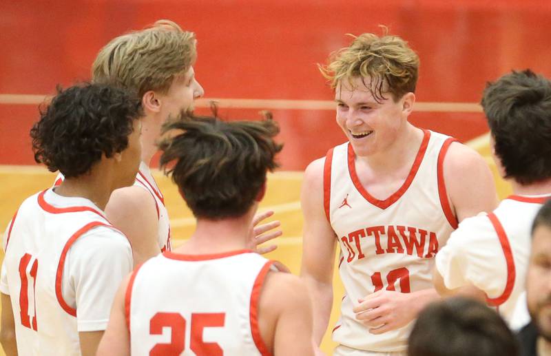 Ottawa's Evan Snook reacts with teammates after hitting the winning shot against Pontiac during the Dean Riley Shootin' The Rock Thanksgiving Tournament on Monday, Nov. 25, 2024 in Kingman Gym at Ottawa High School.