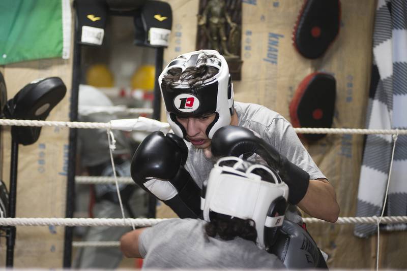 Alex Mazzarisi, 20, spars with Javier Marquina, 30, Wednesday, Feb. 2, 2022 at Gladiator Boxing Club in Sterling. Trained by his father Steve, Alex will be competing March 7 for the Golden Gloves title in Cicero. With success there, the duo has eyes set on Nationals and the Olympic trials.