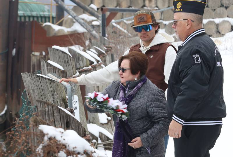 Irma Valle, throws a wreath into the Illinois River as her grandson Gino and Dennis Znaniecki commander of the American Legion Post 375 watch during the 46th annual Peal Harbor parade and Memorial service at the South Shore Boat Club in Peru.