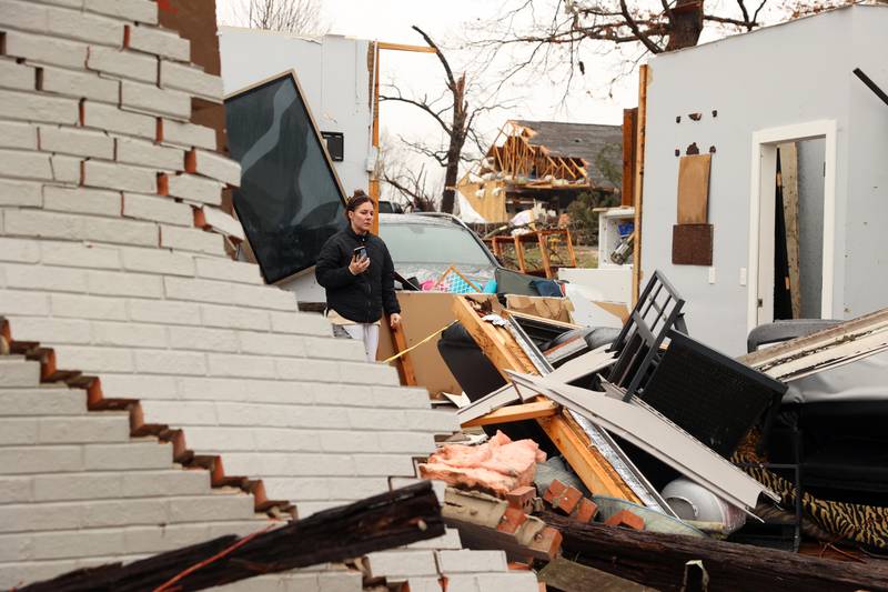 Emily LaVoie surveys the damage to her home along Elmwood Drive in Aroma Township on Wednesday, March 11, 2026, following the March 10 tornado in Kankakee County.