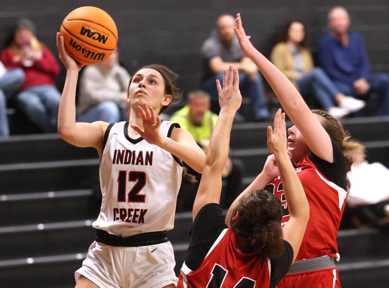 Indian Creek's Isabella Turner shoots over two Aurora Christian defenders during their game Monday, Nov. 25, 2024, at Indian Creek High School in Shabbona.