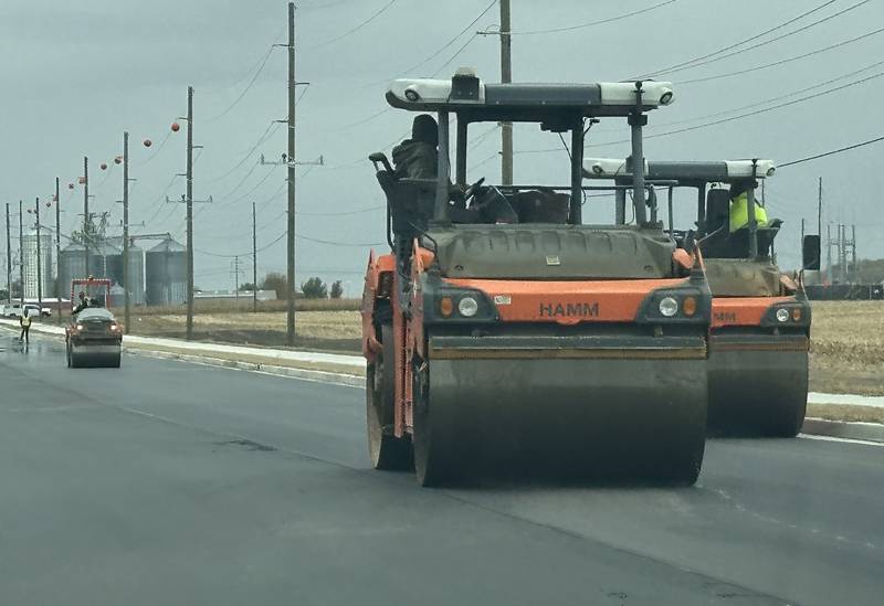 Crews from Advanced Asphalt pave the final coat of asphalt on Plank Road on Tuesday, Oct. 21, 2025 in Peru. The first of three phases of Plank Road construction have been compleated The temporary stoplights have been removed from the construction zone. The project involved a new turn lane, wider lanes in both directions, curb and gutter, and addition of a recreation trail. Future plans are to reconstruct the road all the way to Interstate 80.