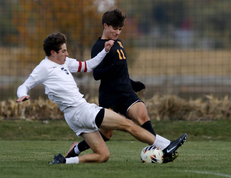 F.W. Parker's F.W. Parker's Heath Albert slides to knock the ball away from Richmond-Burton's Jack Meyer during an IHSA Class 1A Johnsburg Sectional semifinal match on Oct. 28, 2025, at Johnsburg High School.
